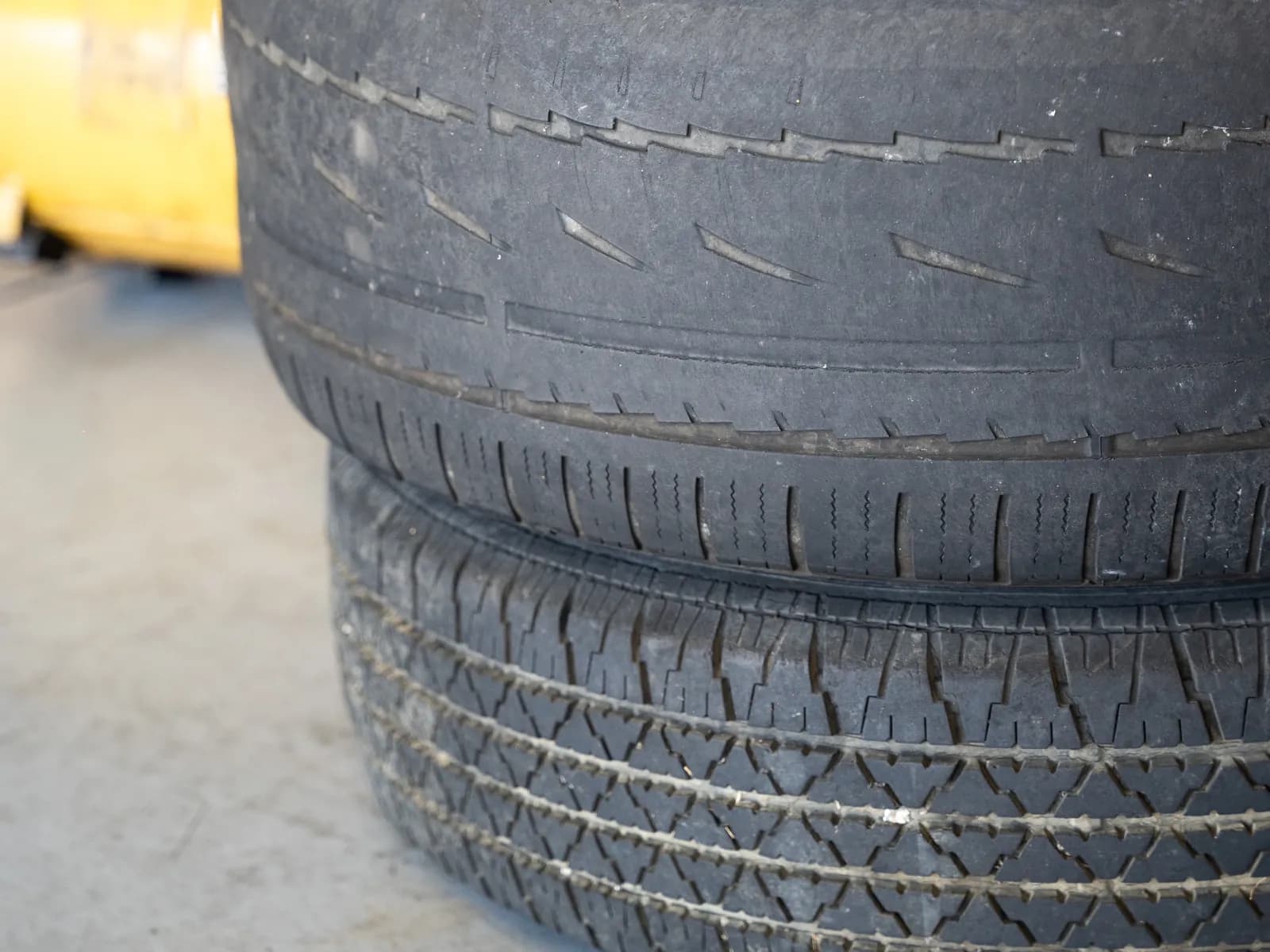 Stacked used tires at Kwik Tire with the tread showing